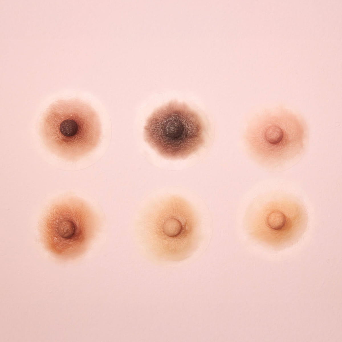 Six silicone prosthetic nipple and areola close-ups in different skin tones — RmonyCare Ready-to-Wear Collection